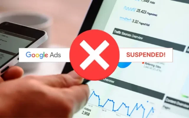 Close-up of a hand interacting with a tablet showing Google Ads data with a large red "X" and the text "SUSPENDED!", highlighting a "google ads suspended circumventing systems" problem.